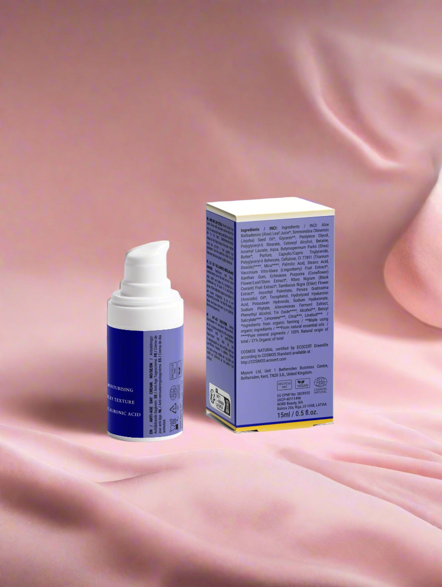 Blue skincare product with pump and box on a pink fabric background