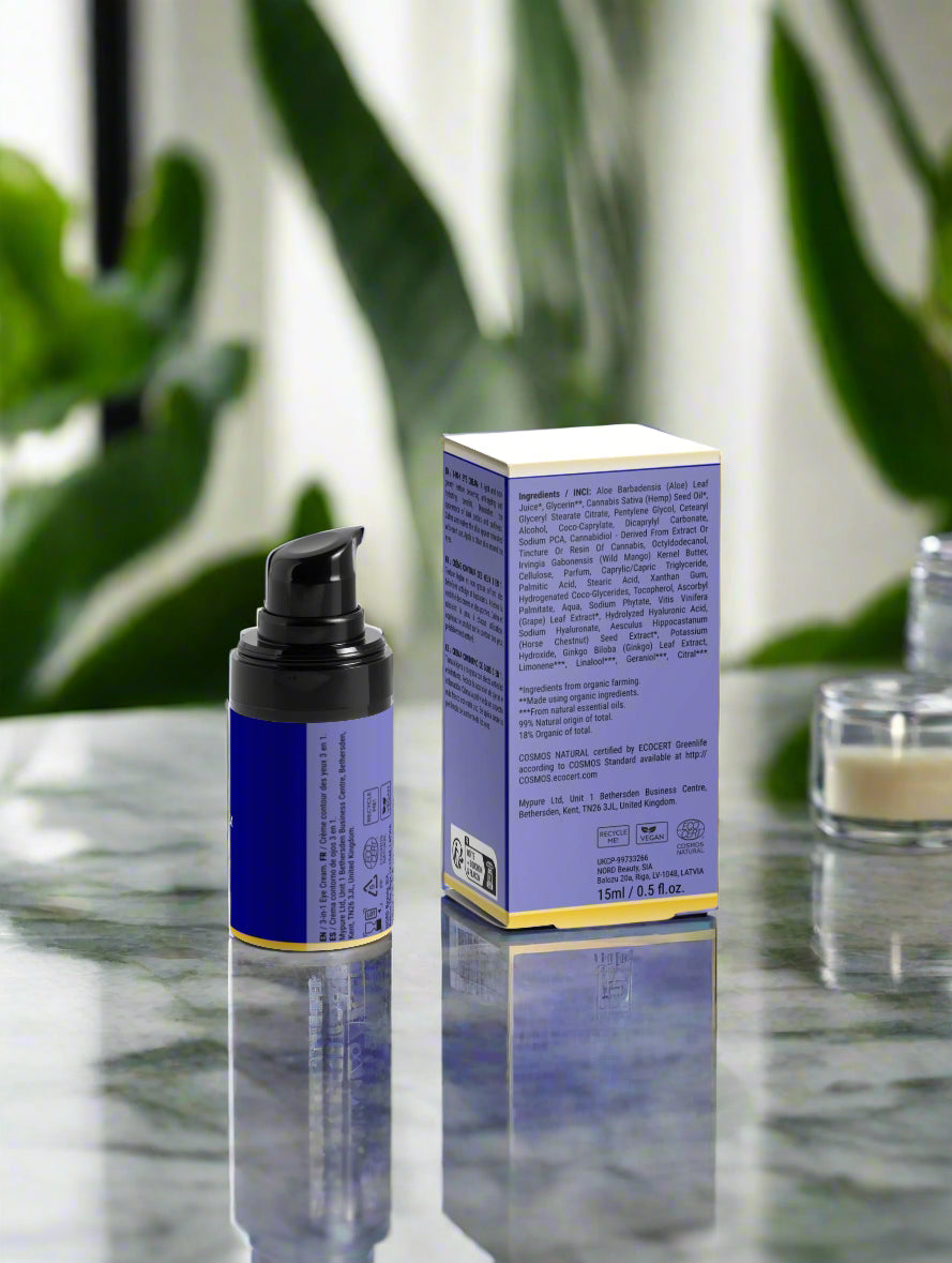 Cosmetic bottle and box with a blurred green plant background
