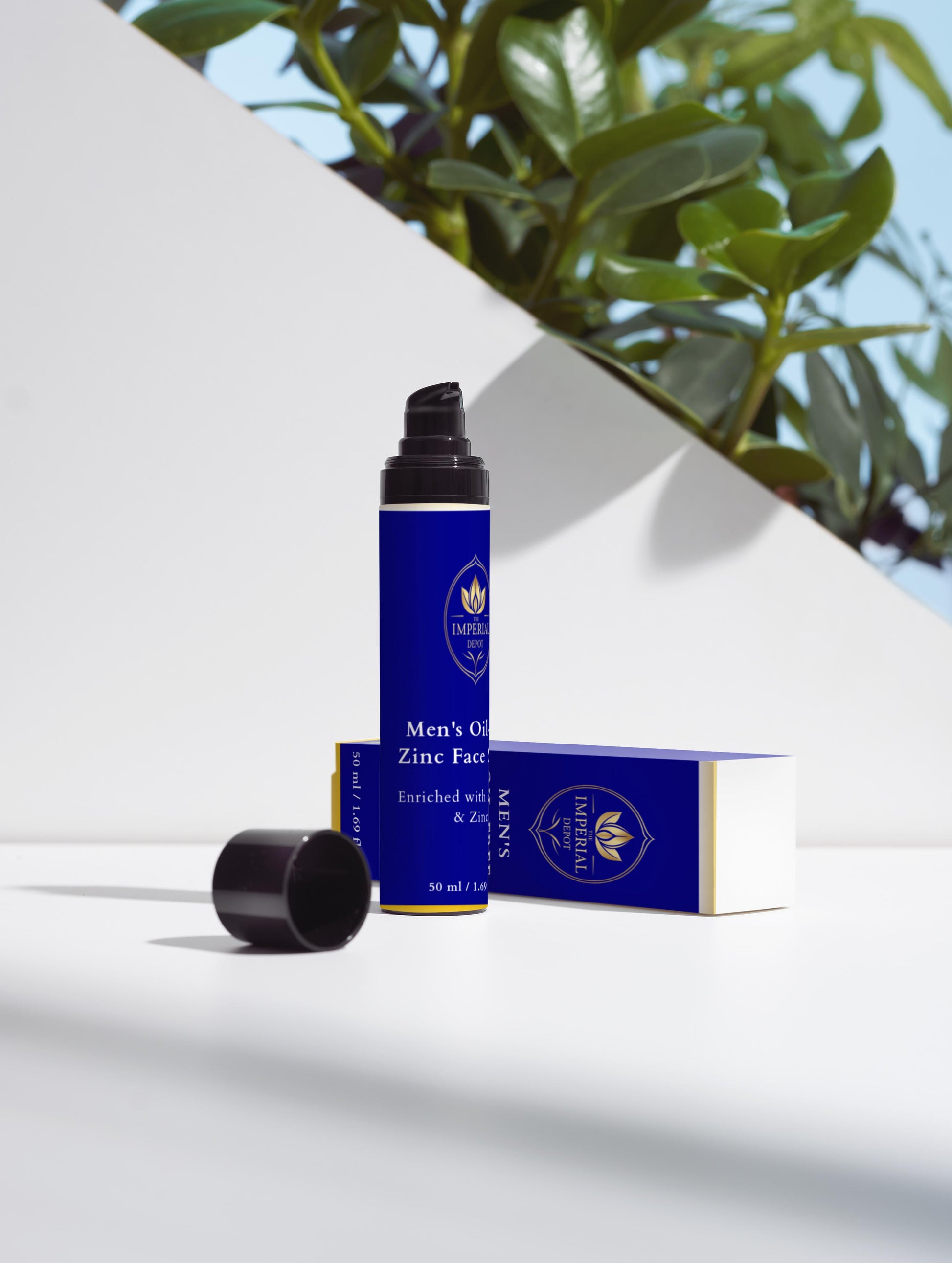 Blue bottle and box of Men's Only Zinc Face Wash on a white surface with green leaves in the background