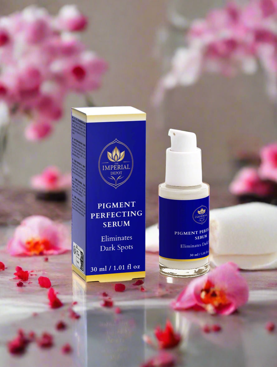 Pigment Perfecting Serum bottle and packaging with pink flowers in the background