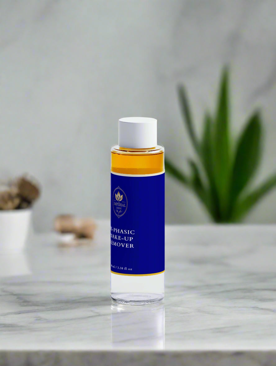Bottle of facial cleanser with blue label on a marble surface