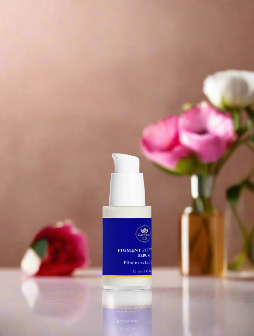 Skincare serum bottle with flowers in the background on a reflective surface